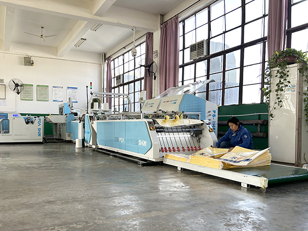 1701922188972209.jpeg 12月6日,操作人員在整理自動(dòng)化切縫套印圈上口尿素袋    600.jpg